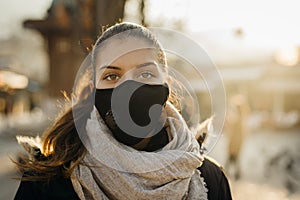 Worried depressed woman walking to work in the public during the pandemic.Effect of the COVID-19.Protective measure,mask wearing.