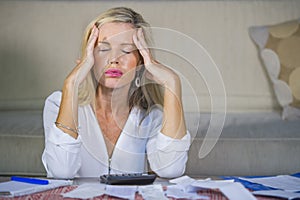 Worried and desperate blond woman calculating domestic money exp