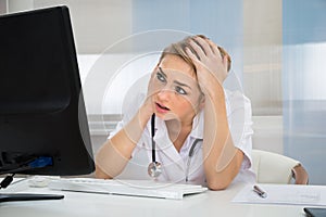 Worried Doctor Looking At Computer