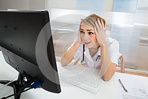 Worried doctor looking at computer