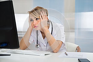 Worried Doctor Looking At Computer