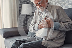 Worried elder senior man feeling bad, upset old middle aged grandfather touching chest feel sudden pain heartburn having heart
