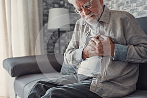 Worried elder senior man feeling bad, upset old middle aged grandfather touching chest feel sudden pain heartburn having heart