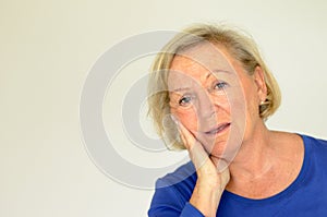 Worried elderly lady looking at the camera