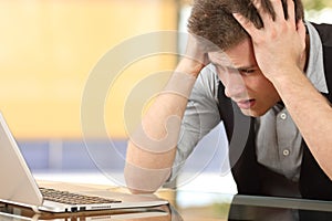 Worried entrepreneur watching laptop