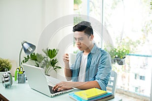 Worried entrepreneur young man working at desk on laptop looking