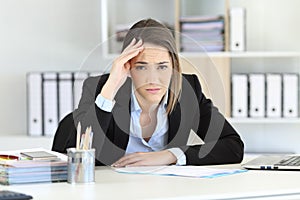 Worried executive looking at camera at office