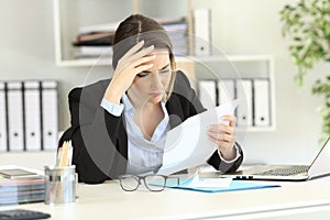 Worried executive reading a letter at office