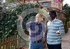 Worried farmer discussing with friend