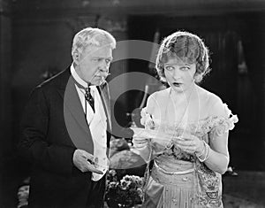 Worried father and daughter looking at a letter