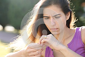 Worried fiancee looking at ring