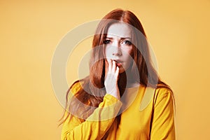 worried frightened young woman covering her mouth with her hand