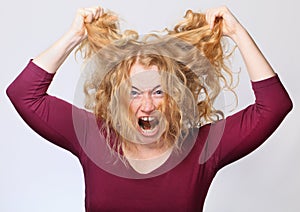 Worried and frustrated young woman with long blond hair