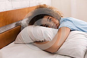 Worried girl hugging pillow and having depressing thoughts