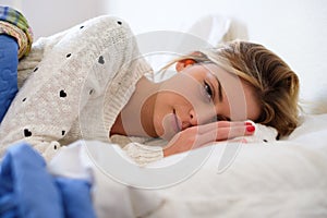 Worried girl lying on the bed having to wake up