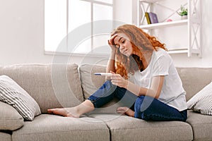 Worried girl reading the results of her pregnancy test