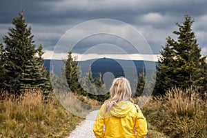 Worried hiker looking at coming storm clouds