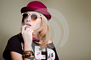 Worried hipster girl in funny retro outfit biting