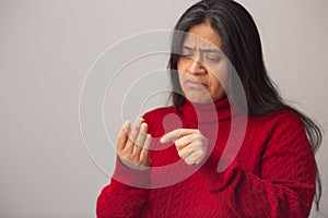 Worried Hispanic Woman Counts On Fingers