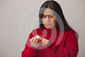 Worried Hispanic Woman Looks At Fingers