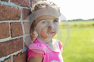 Worried little girl brick house