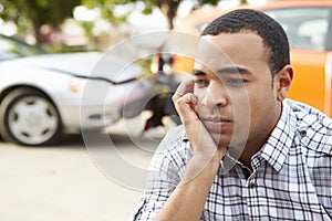 Worried Male Driver Sitting By Car After Traffic Accident