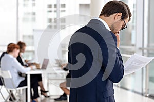 Worried male speaker read notes afraid of public speaking