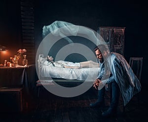 Worried man against dead woman, soul left body