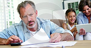 Worried man calculating bills