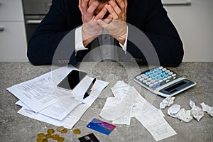Worried man calculating budget and finances