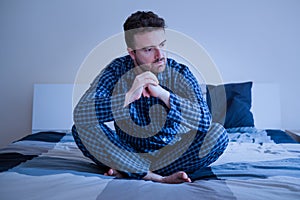 Worried man can`t sleep thinking about problems