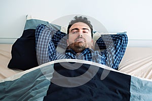 Worried man can`t sleep thinking about problems