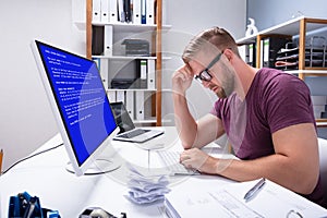 Worried Man At Computer With System Failure On The Screen