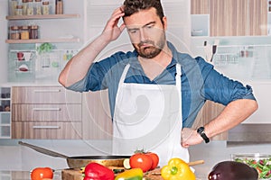 Worried man before cooking at home for dinner photo