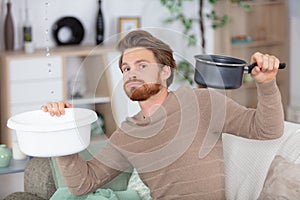 worried man having leakage water falling at home