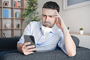 Worried man at home reading bad news about coronavirus contagion