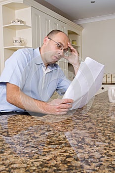 Worried man in kitchen