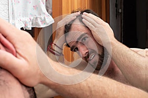 worried man looking his hair loss on the mirror, young guy beginning alopecia problem, examining scalp balding distressed