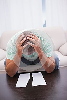 Worried man looking at ripped page