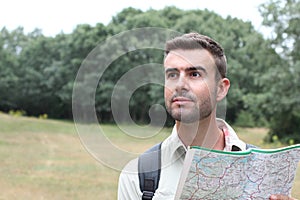 Worried man lost hiking confused looking at map