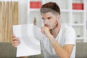 worried man reading correspondence