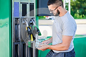 Worried man shocked how much gasoline costs.