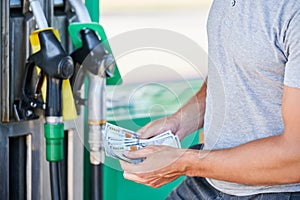 Worried man shocked how much gasoline costs.