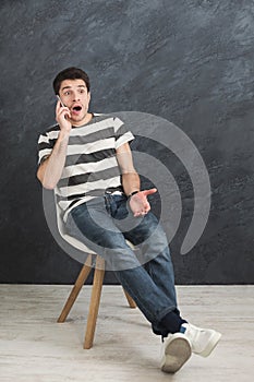 Worried man talking on phone in studio