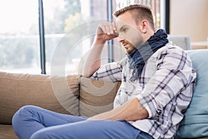 Worried man thinking on the couch