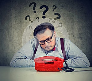 Worried man with too many questions waiting for a call