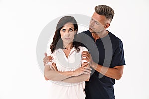 Worried man trying to comfort his girlfriend while standing