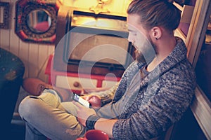 Worried man typing a message. Young man using smart phone typing