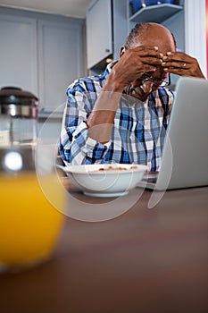 Worried man using laptop