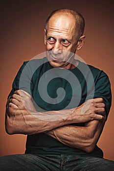 Worried mature man sitting at studio